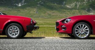 Zwei geparkte rote Autos.